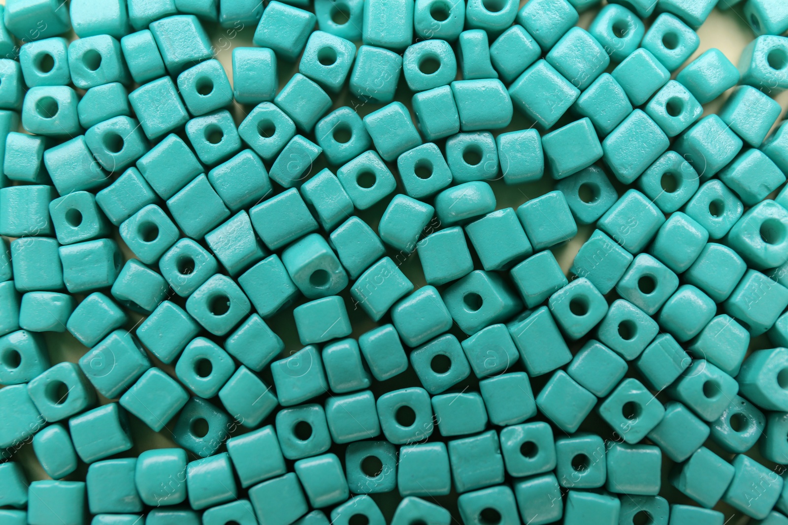 Photo of Bright turquoise beads as background, top view