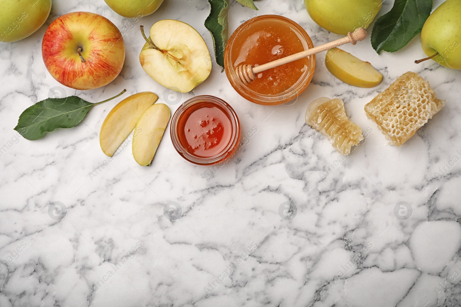 Photo of Flat lay composition with honey, apples, dipper and honeycombs on marble background