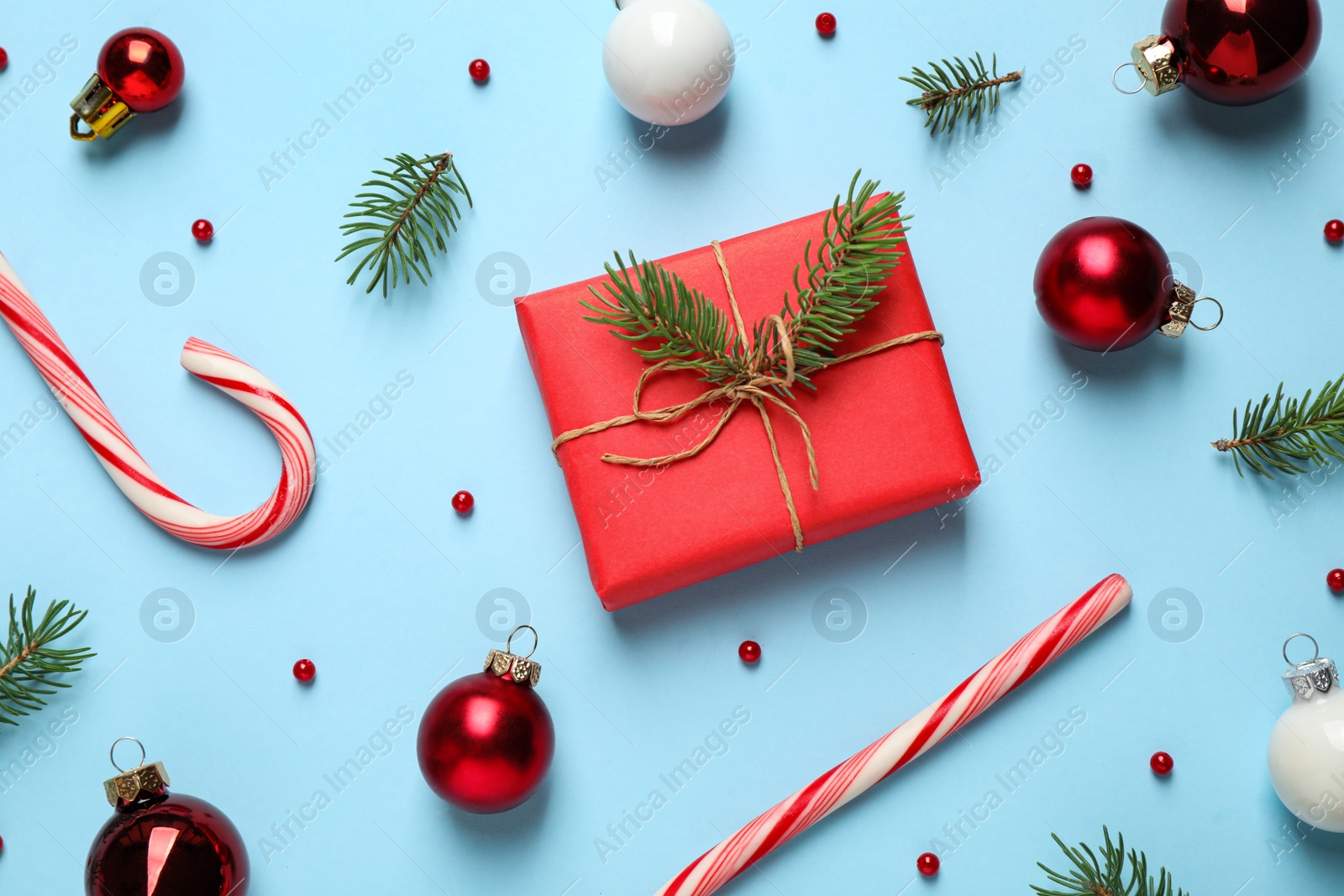 Photo of Flat lay composition with Christmas decorations on light blue background