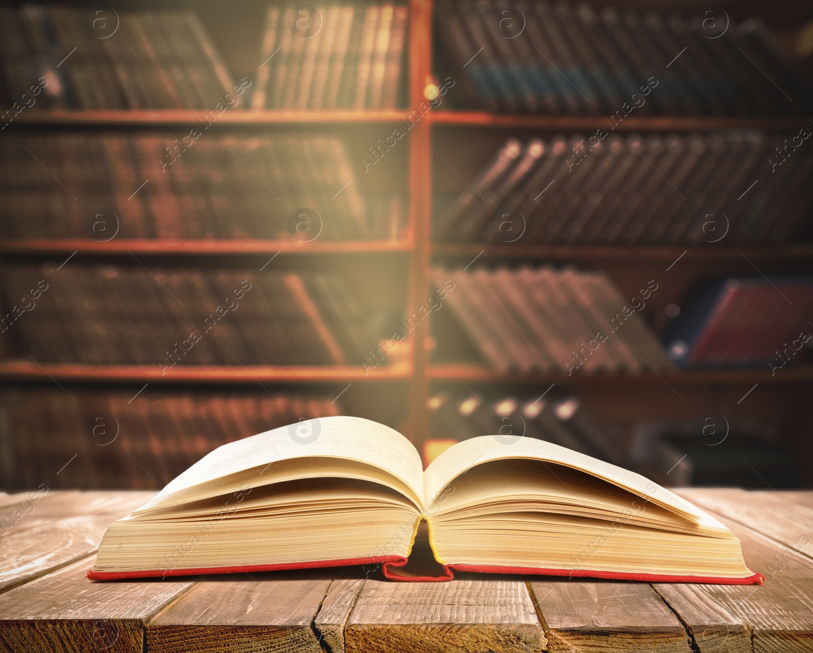 Image of Open book on wooden table in library