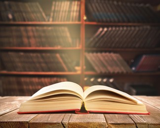 Image of Open book on wooden table in library