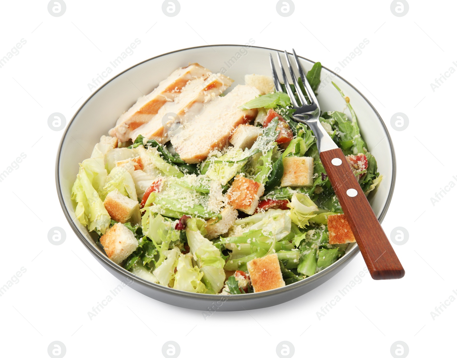 Photo of Delicious Caesar salad in bowl isolated on white