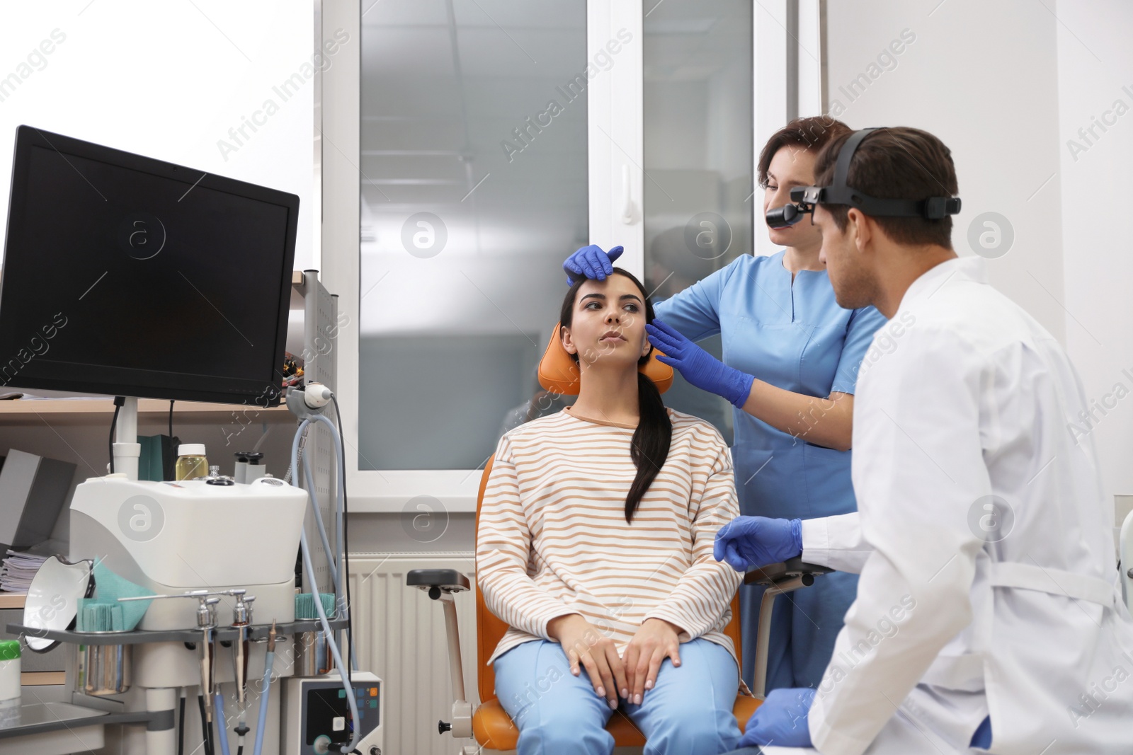 Photo of Professional doctors examining patient before surgery in clinic