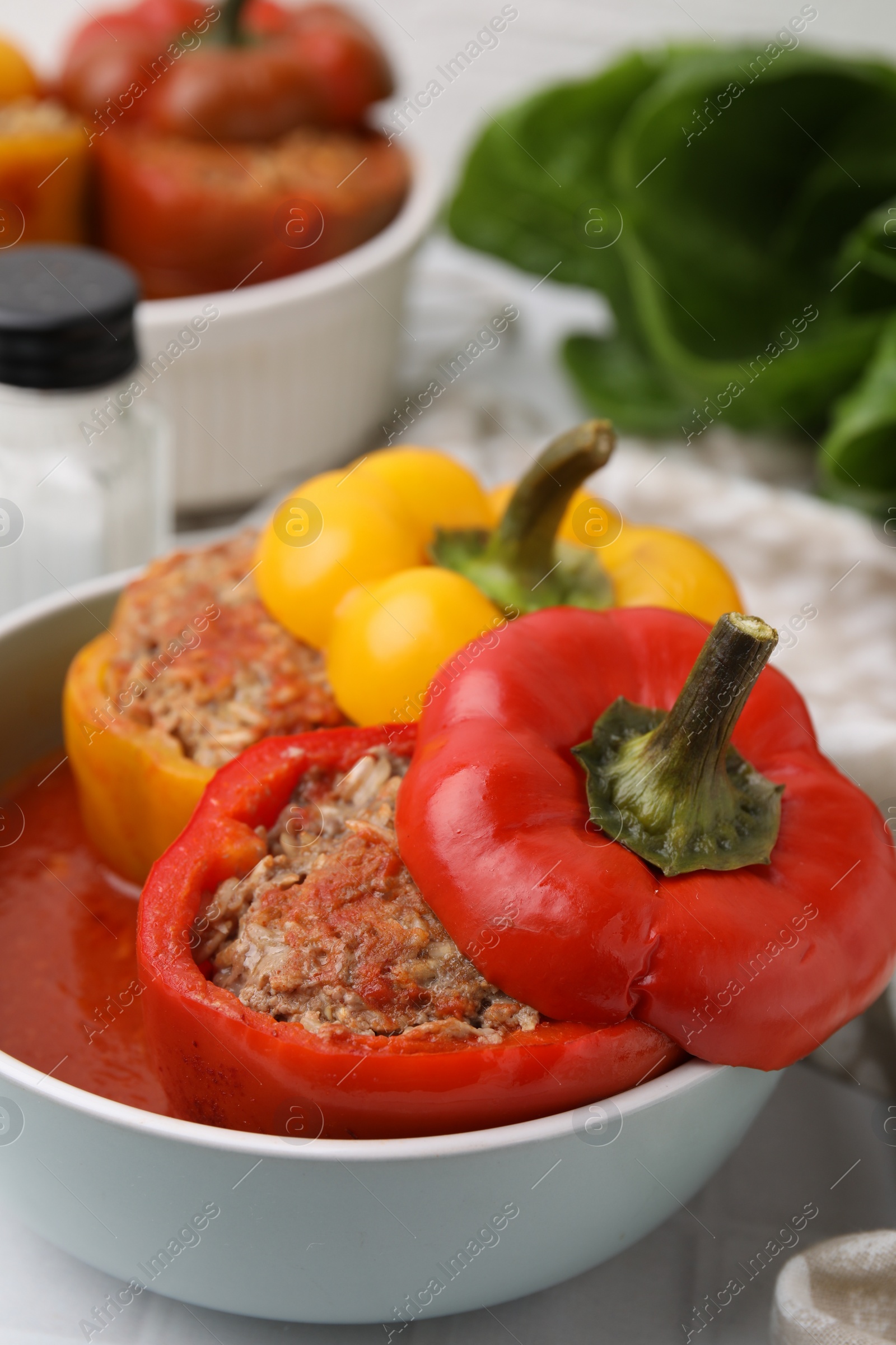 Photo of Delicious stuffed bell peppers on white table, closeup