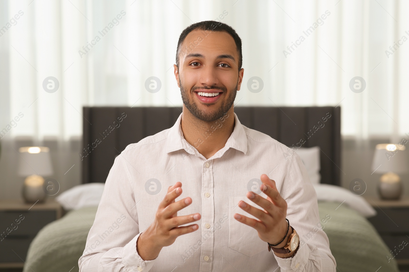 Photo of Young man having online video call at home, view from camera