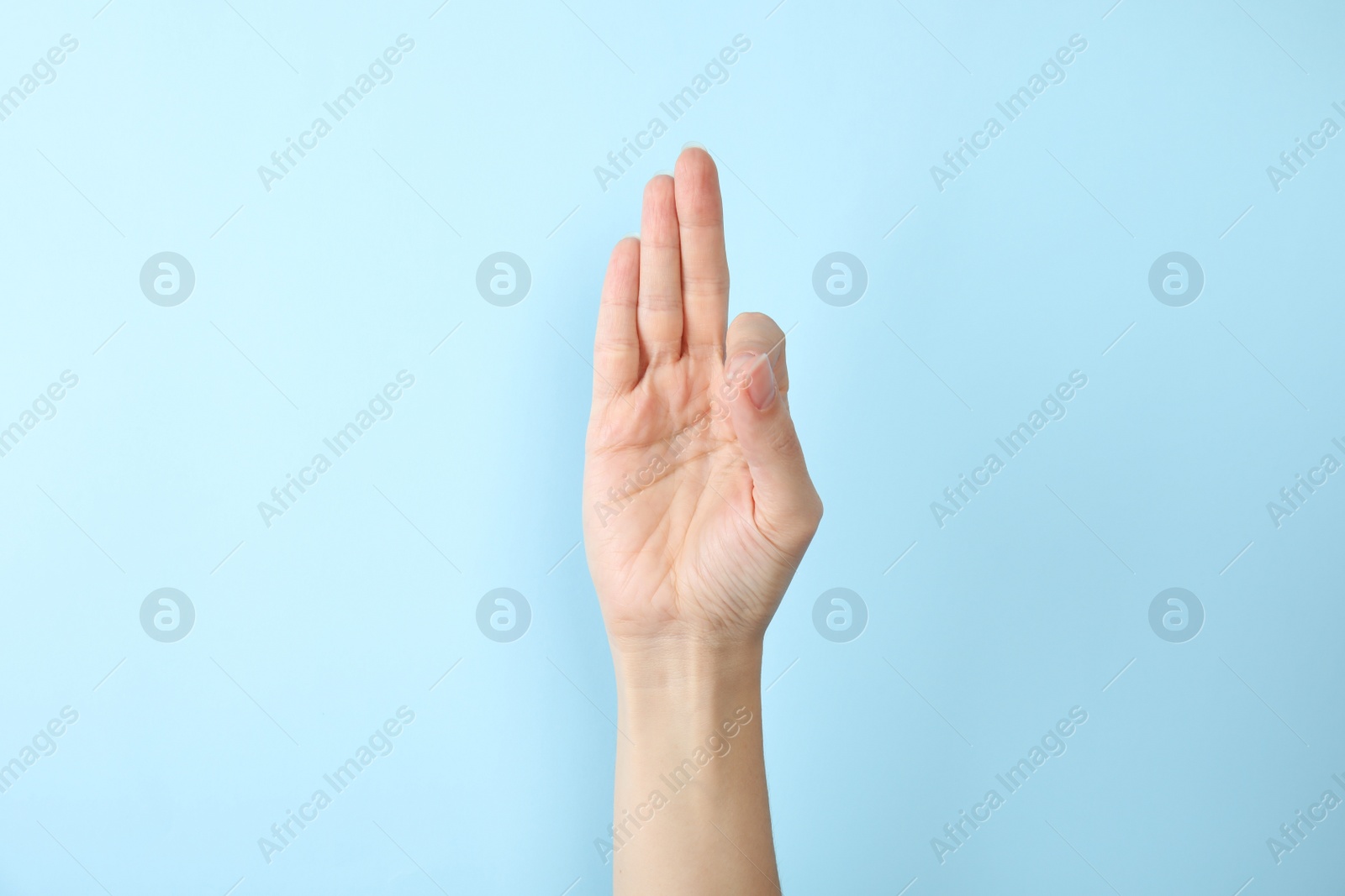 Photo of Woman showing F letter on color background, closeup. Sign language