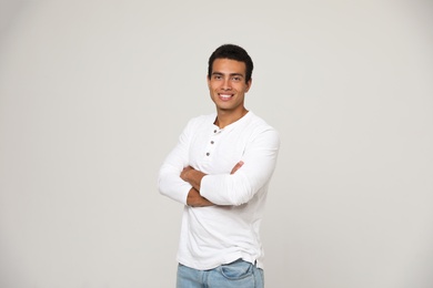 Photo of Handsome young African-American man on light background