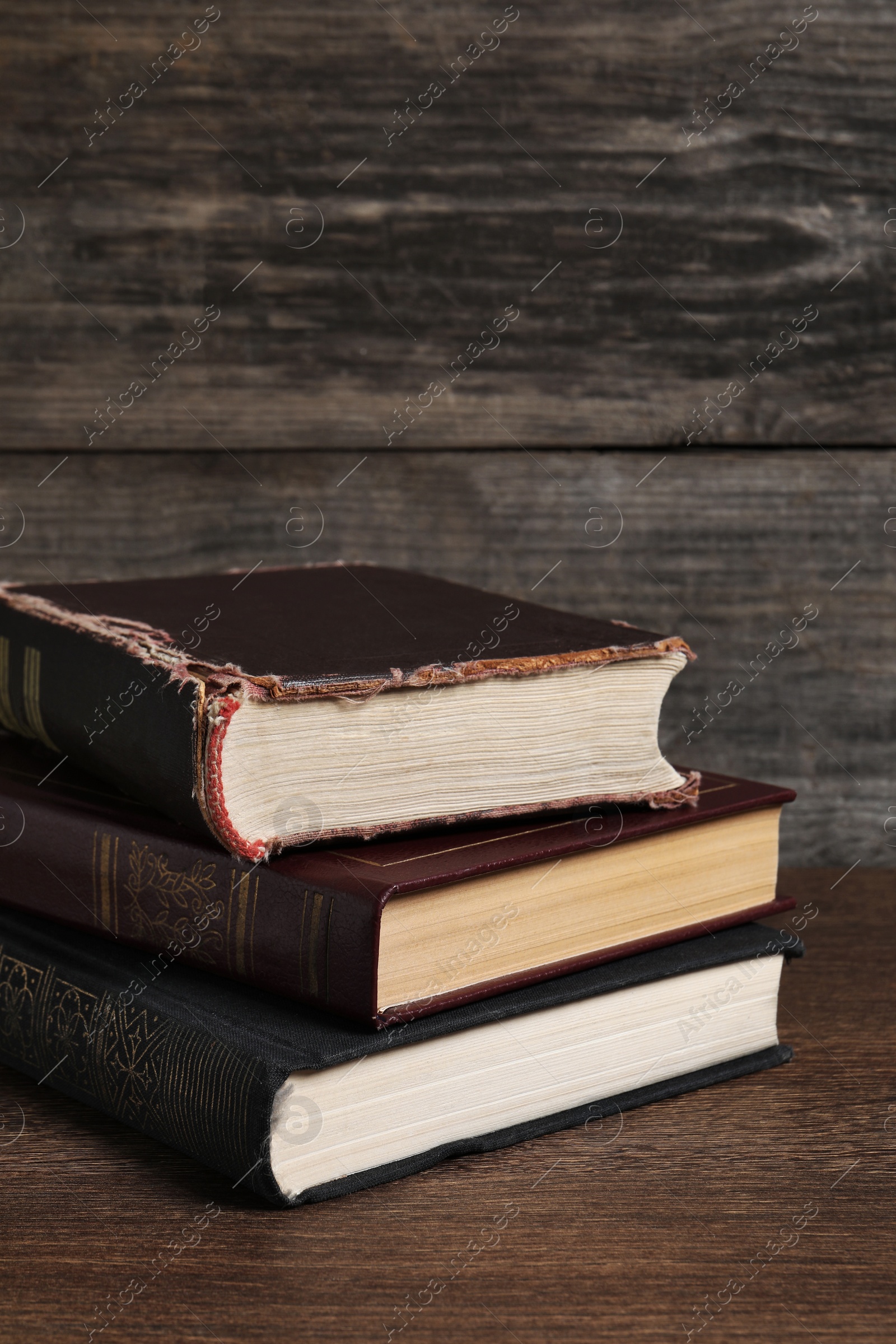 Photo of Stack of old hardcover books on wooden table