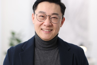 Portrait of smiling businessman on blurred background