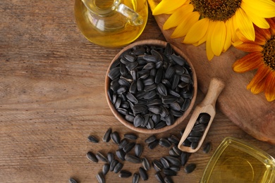 Photo of Flat lay composition with sunflower oil on wooden table