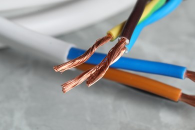 Photo of Colorful electrical wires on gray surface, closeup