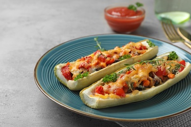 Photo of Delicious stuffed zucchini served on light grey table