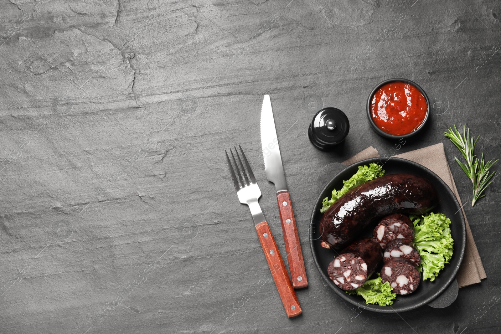 Photo of Tasty blood sausages served on grey table, flat lay. Space for text