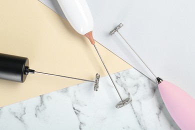 Photo of Milk frother wands on color background, flat lay