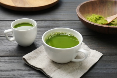 Cups of fresh matcha tea on table