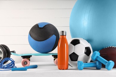 Photo of Many different sports equipment on white table