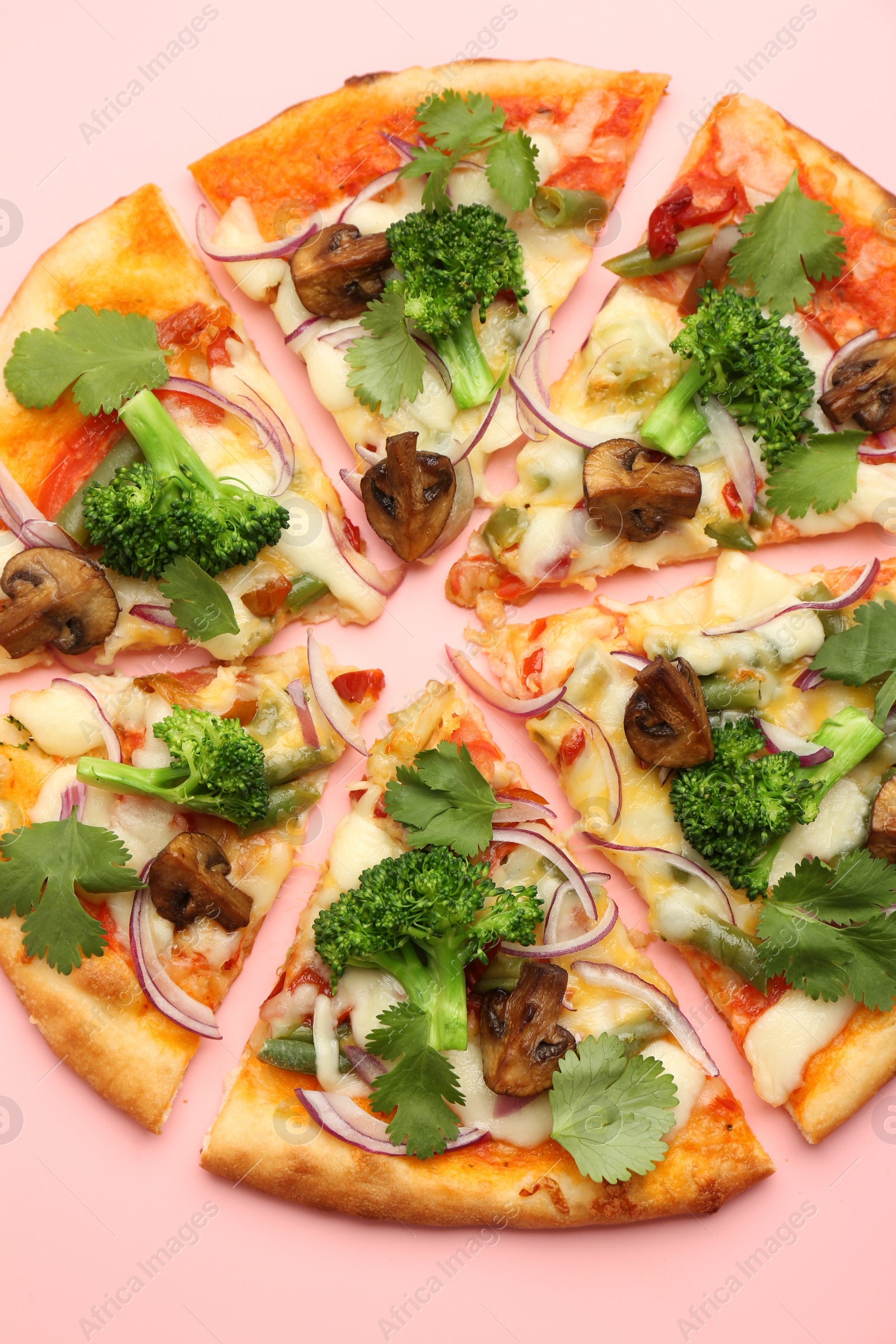 Photo of Delicious vegetarian pizza on pink table, top view