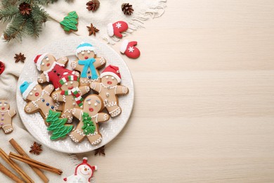 Photo of Flat lay composition with delicious Christmas cookies on beige wooden table, space for text