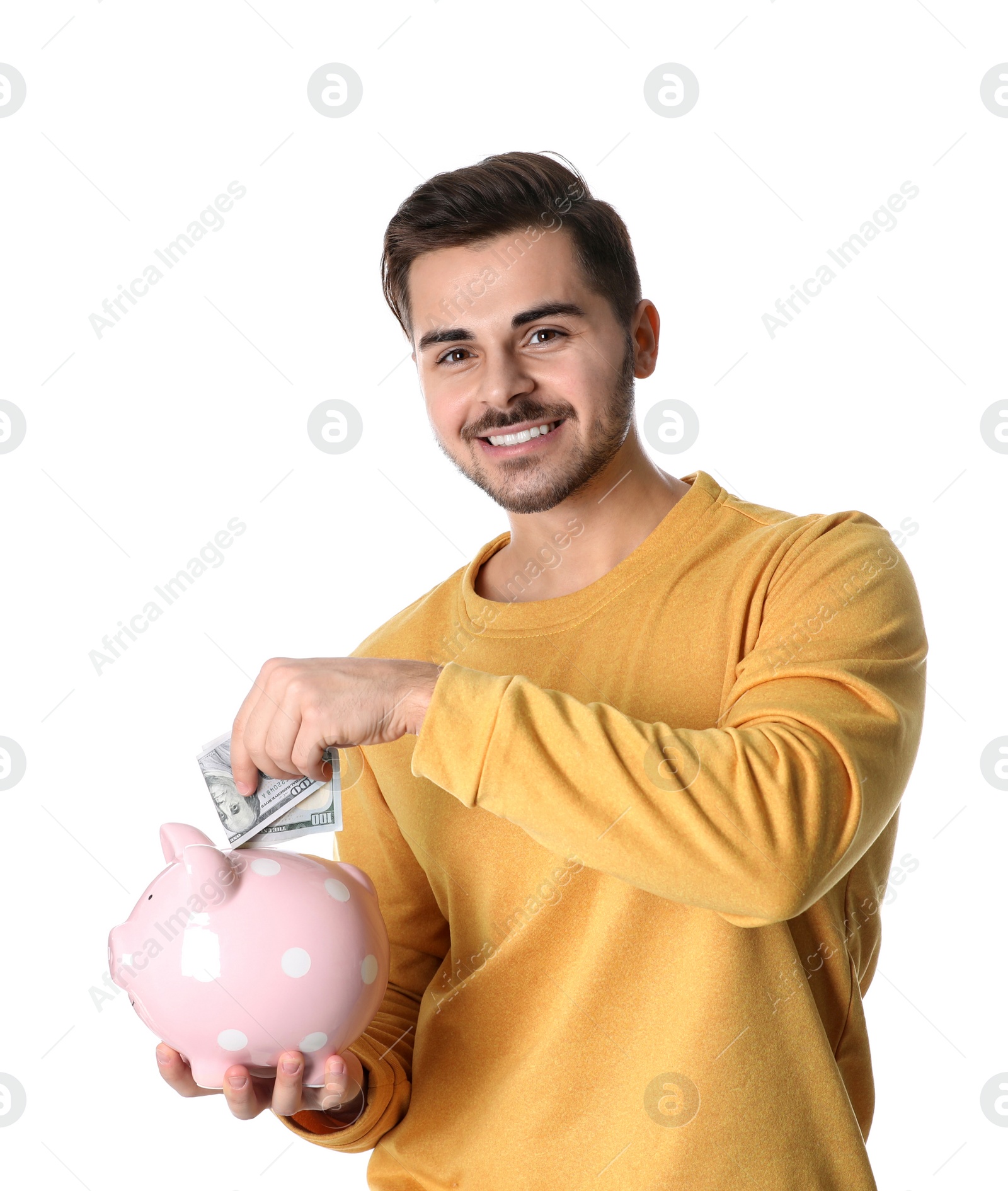 Photo of Young man with money and piggy bank on white background