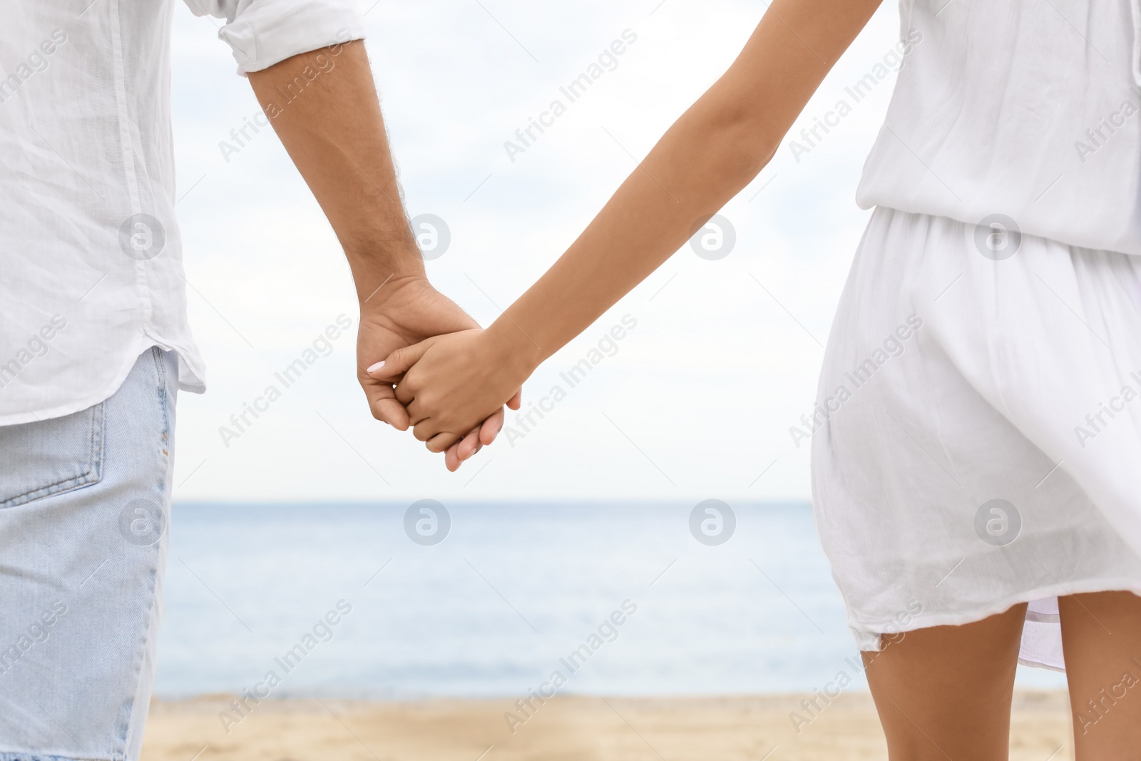 Photo of Lovely couple spending time together on beach, closeup