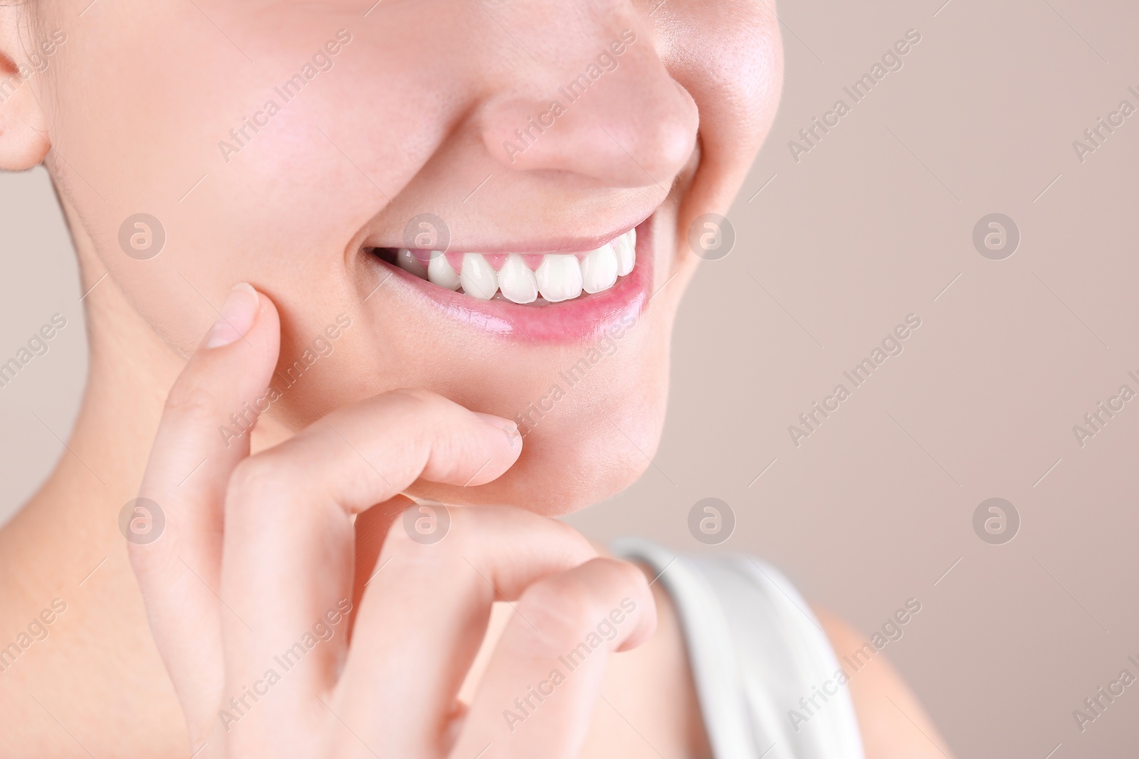 Photo of Young woman with beautiful smile on color background, closeup. Space for text