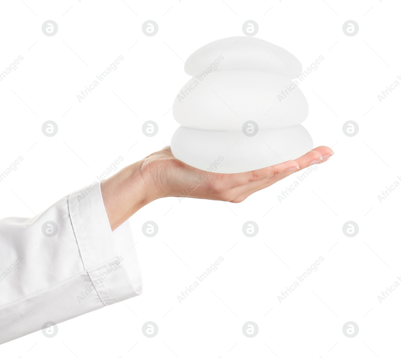 Photo of Doctor holding silicone implants for breast augmentation on white background. Cosmetic surgery