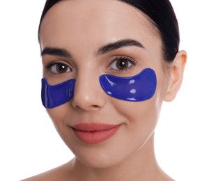 Beautiful young woman with under eye patches on white background