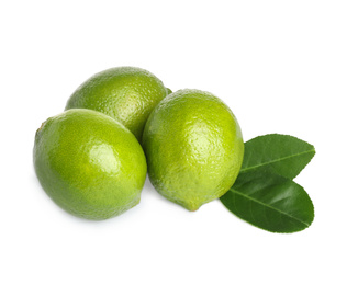 Photo of Fresh ripe limes with green leaves isolated on white