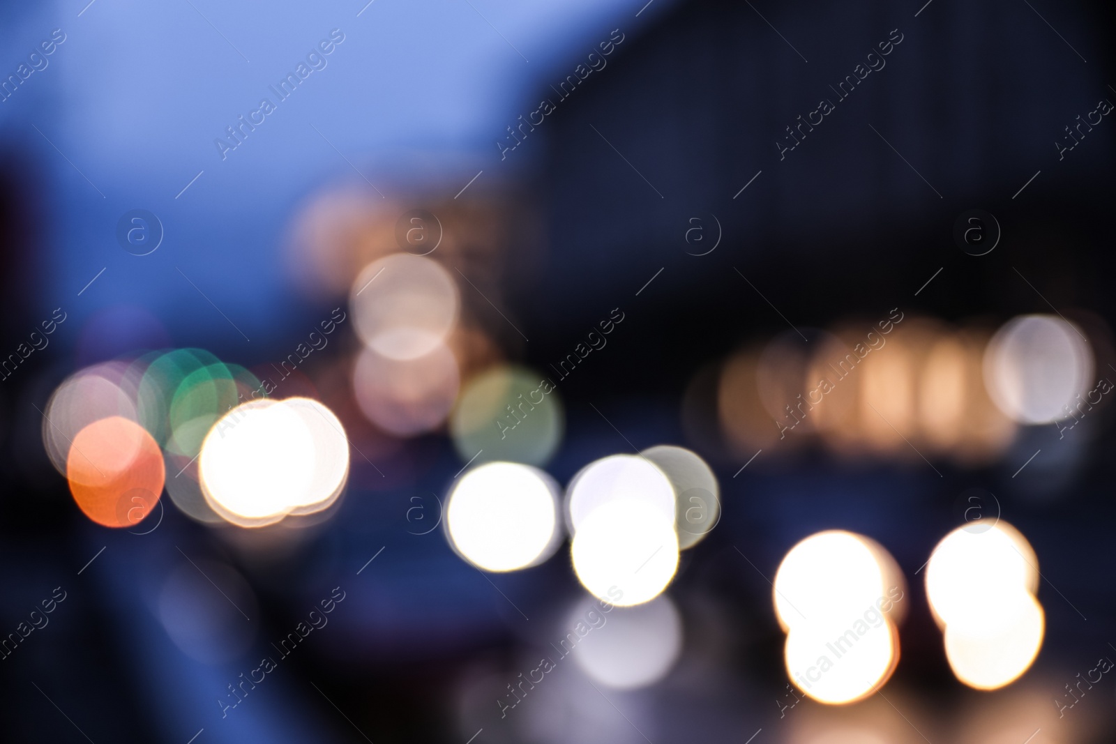 Photo of Blurred view of modern city at evening. Bokeh effect