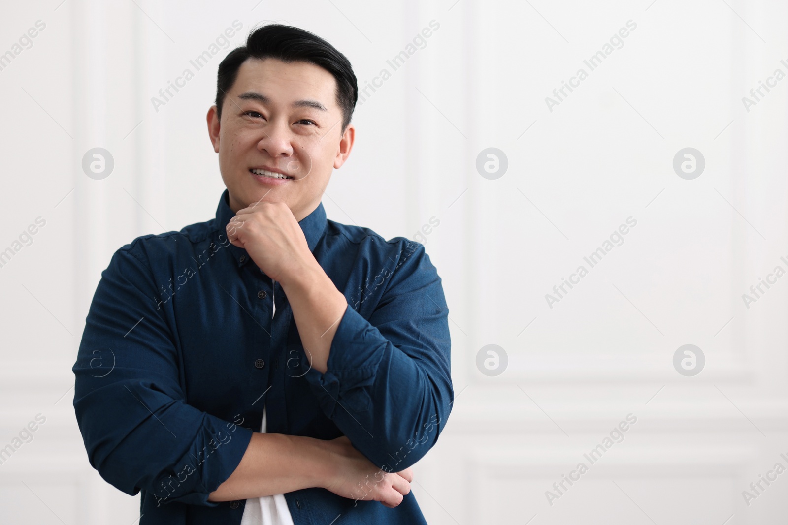 Photo of Portrait of smiling businessman indoors. Space for text