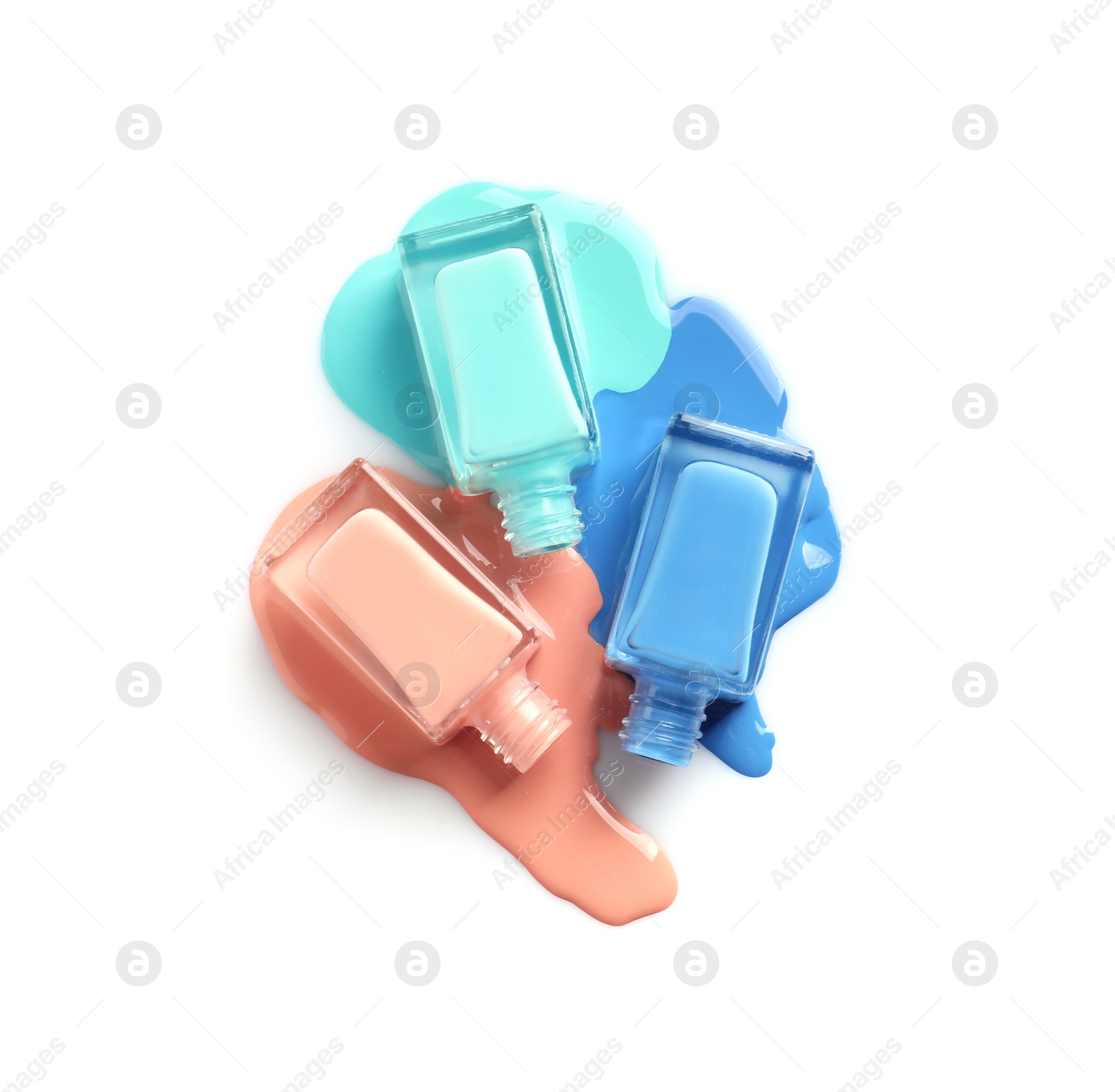 Photo of Spilled different nail polishes with bottles on white background, top view