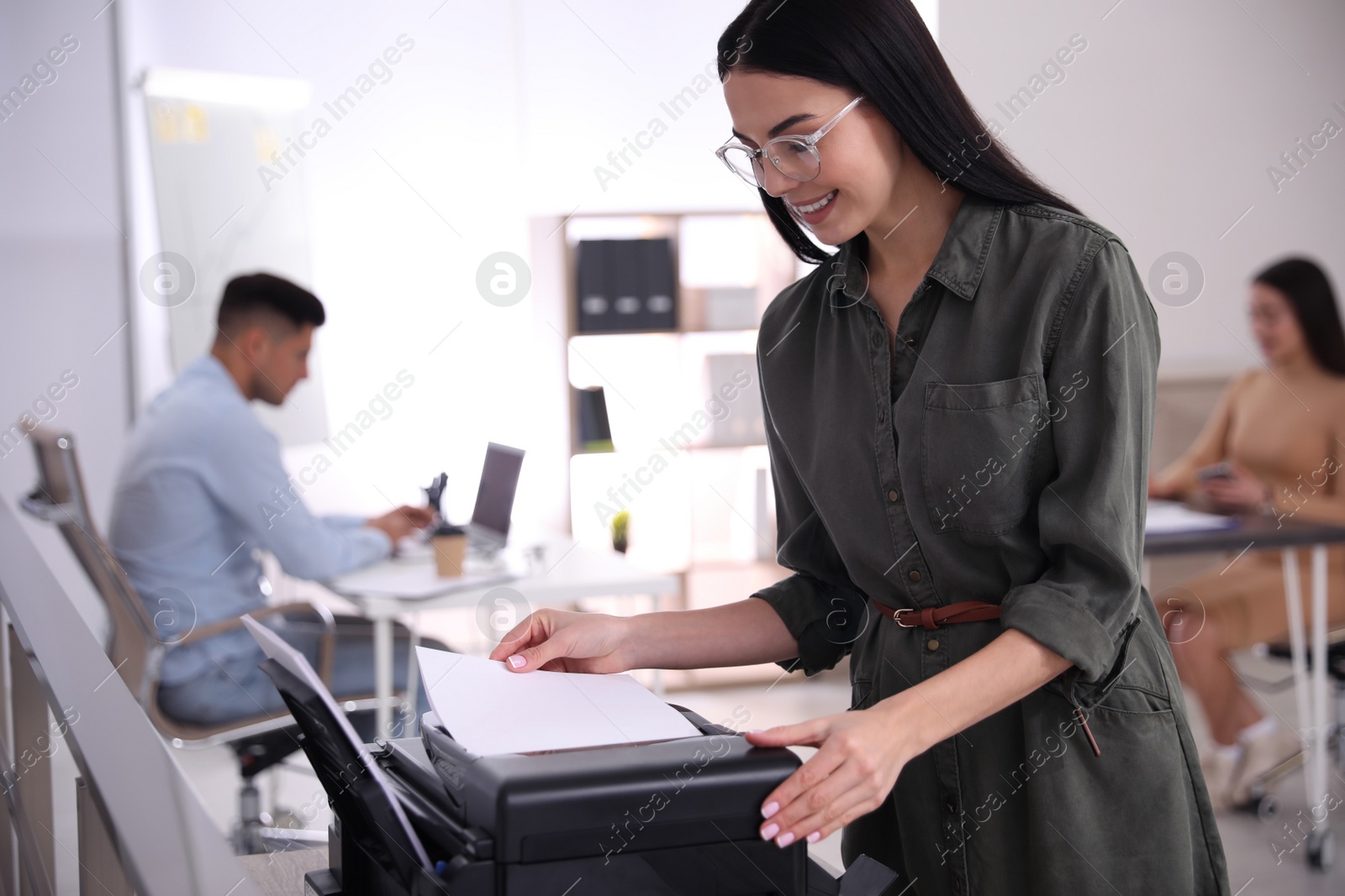 Photo of Employee using new modern printer in office