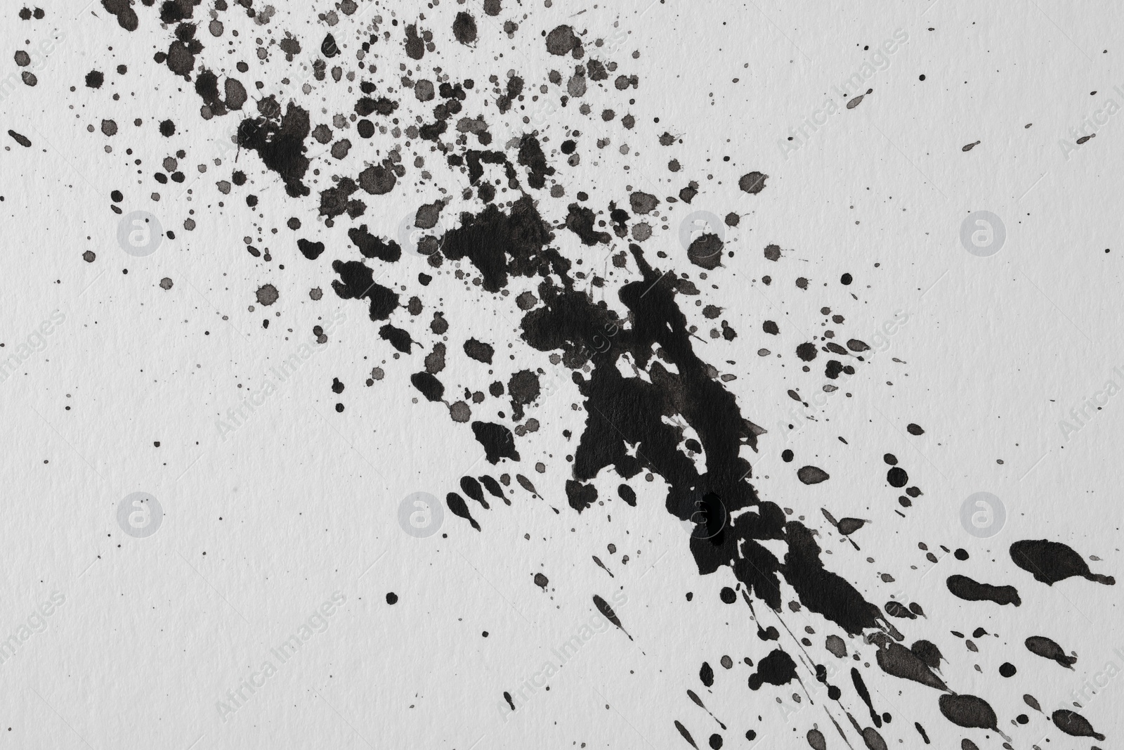 Photo of Blots of black ink on white background, flat lay