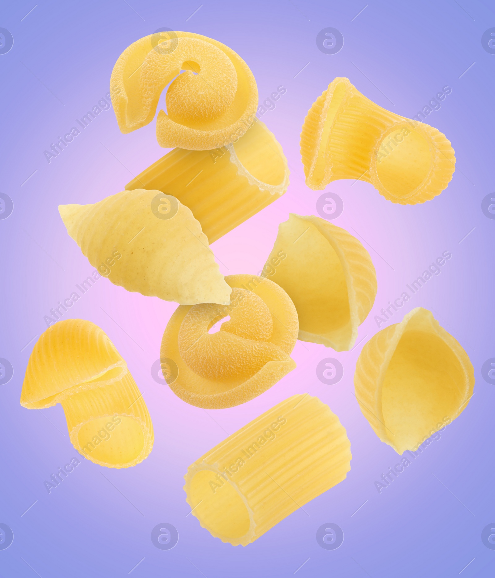 Image of Different types of pasta flying on color background