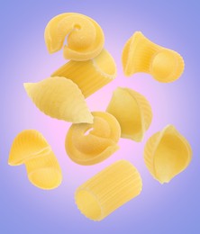 Different types of pasta flying on color background