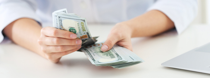 Doctor with bribe at desk in clinic, closeup. Banner design