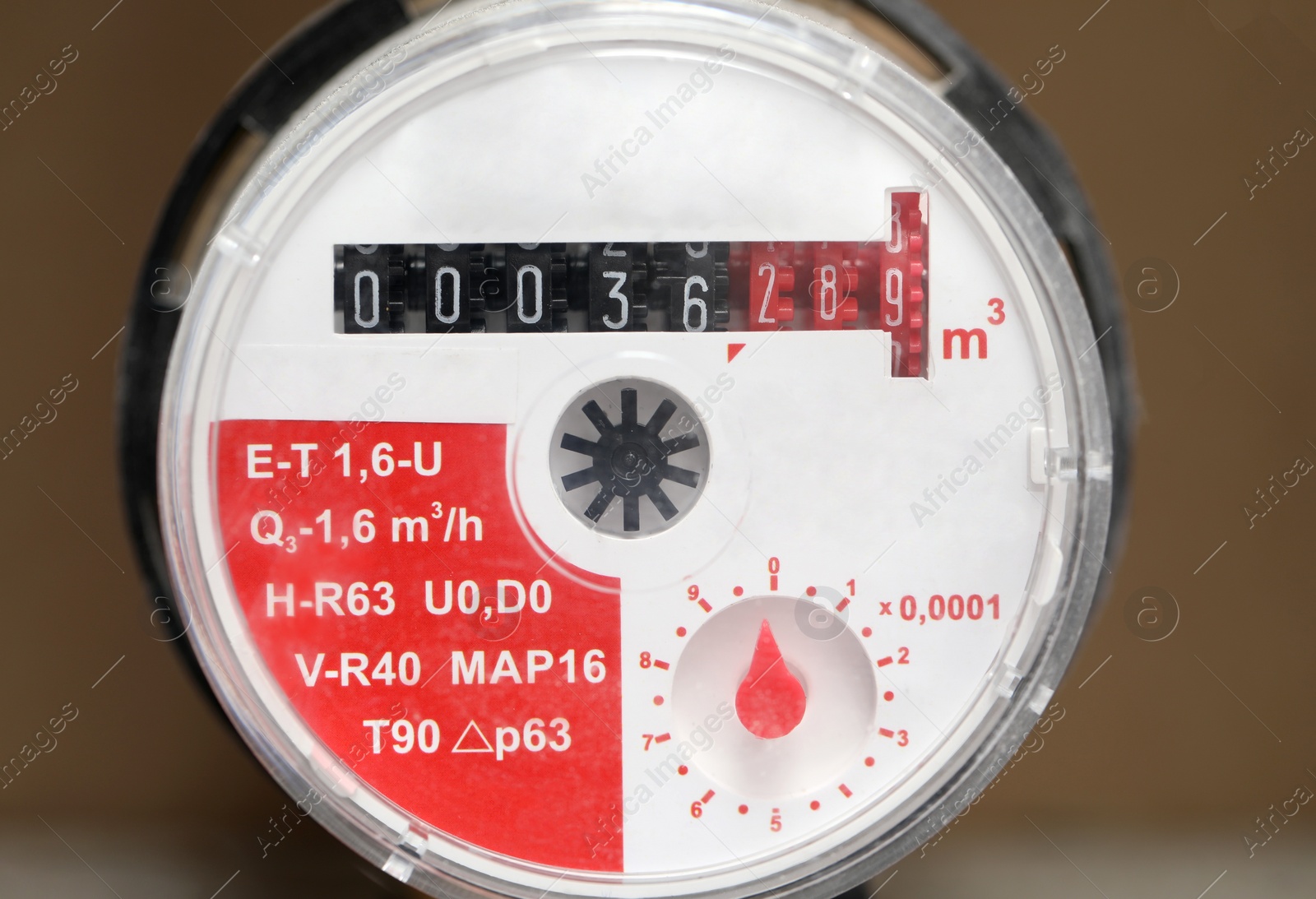 Photo of Electric meter on blurred background, closeup view. Water measuring device