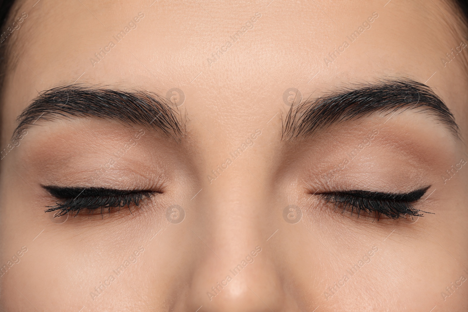 Photo of Young woman with permanent eyeliner makeup, closeup