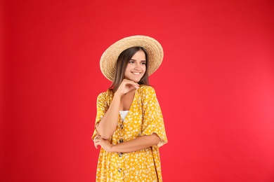 Photo of Young woman wearing stylish yellow dress on red background