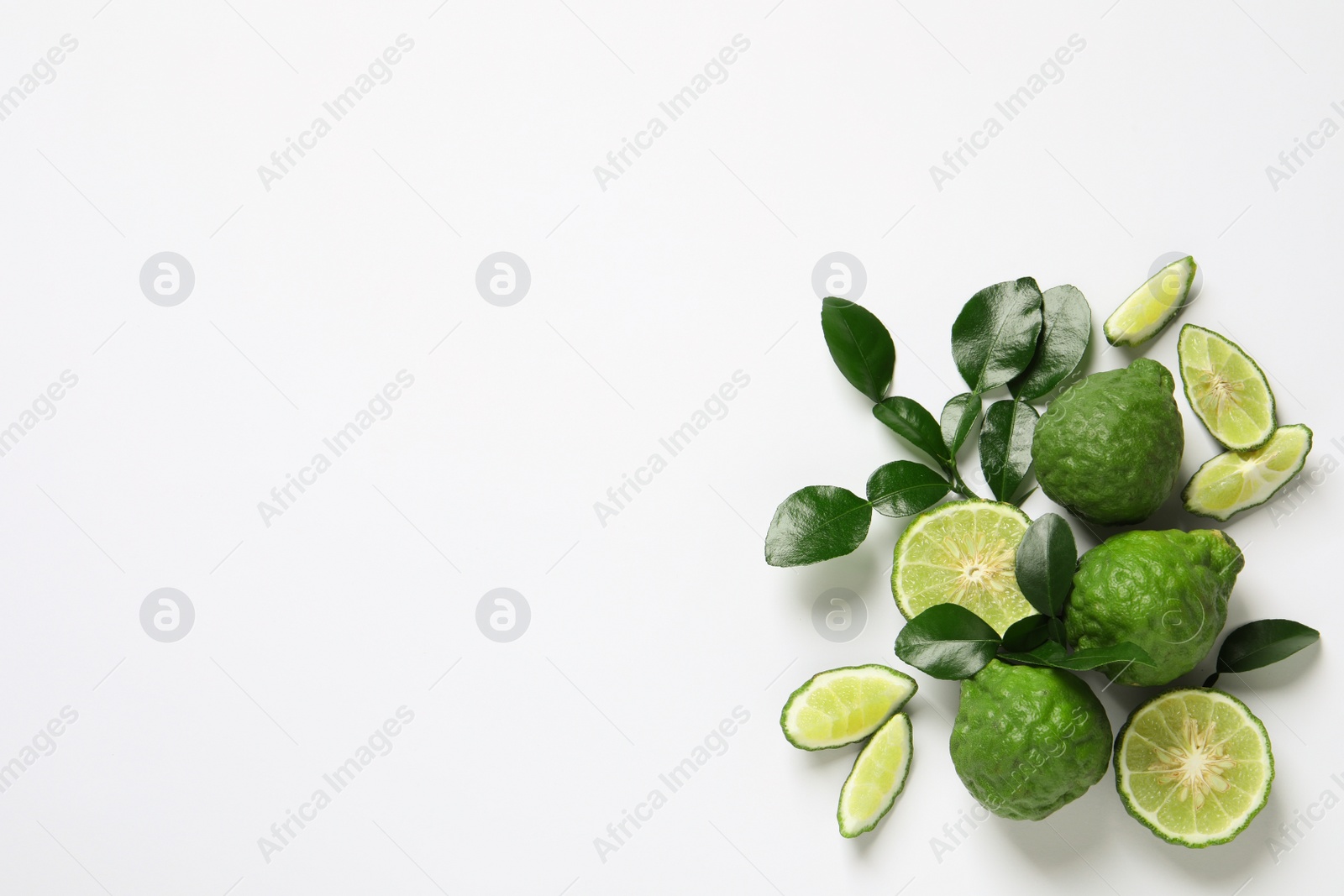 Photo of Flat lay composition with ripe bergamot fruits on white background. Space for text