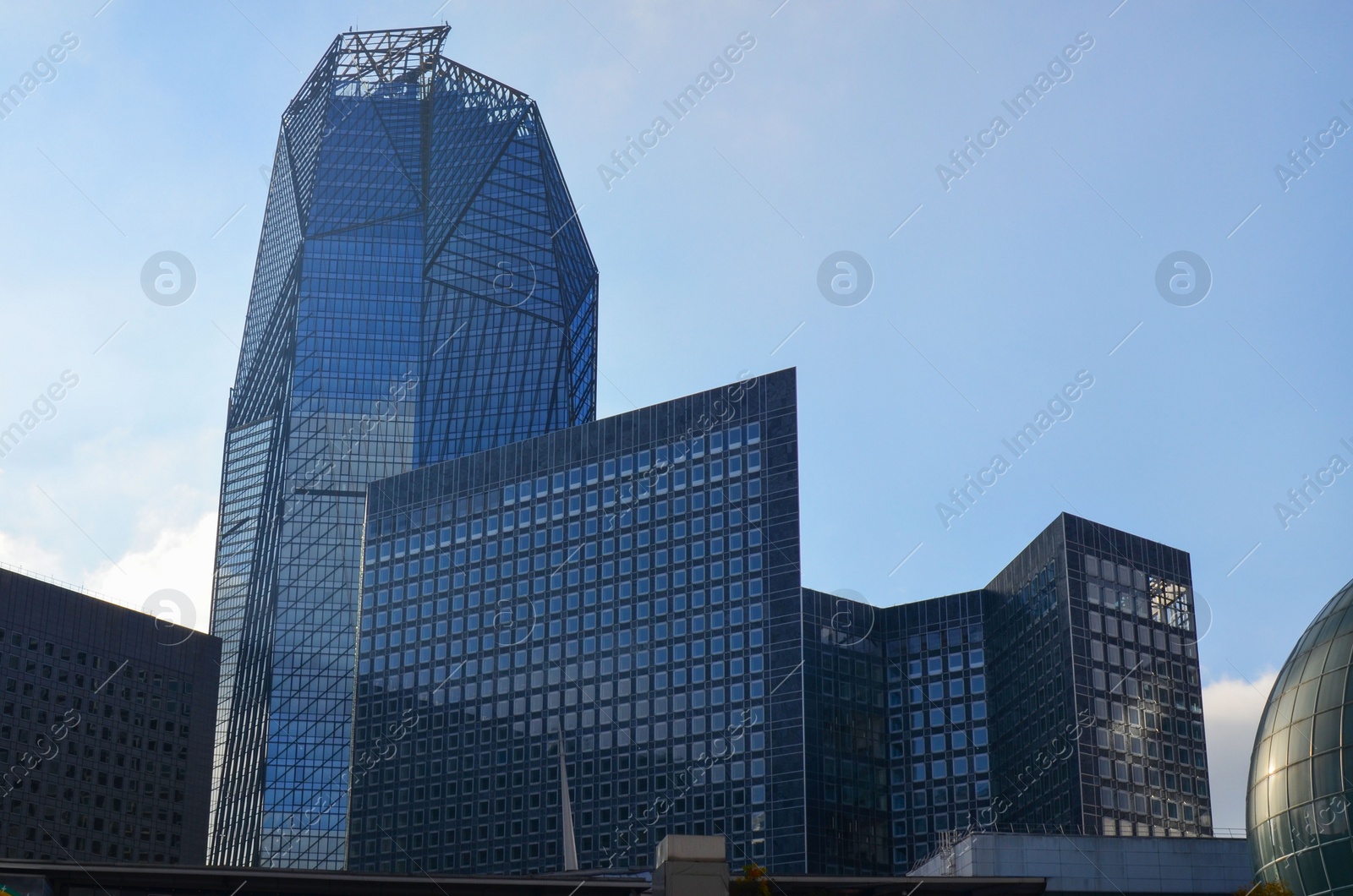 Photo of Exterior of different modern skyscrapers against blue sky