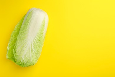 Photo of Fresh ripe Chinese cabbage on yellow background, top view. Space for text