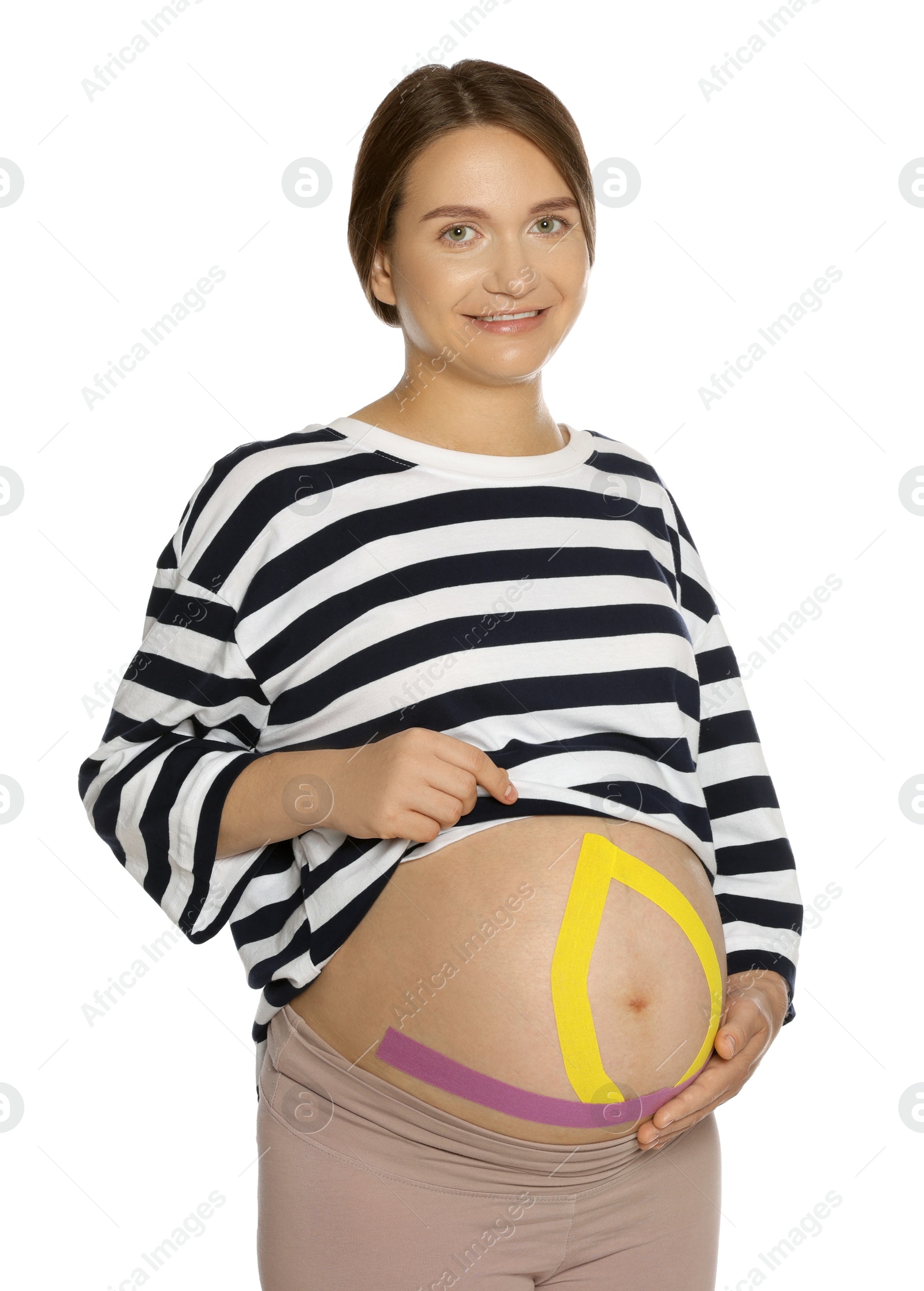Photo of Pregnant woman with kinesio tapes on her belly against white background