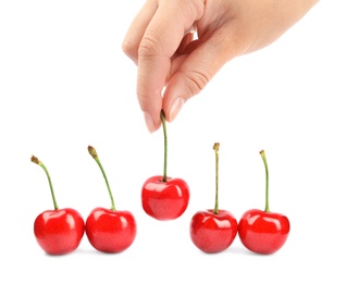 Photo of Woman holding ripe sweet cherry on white background, closeup