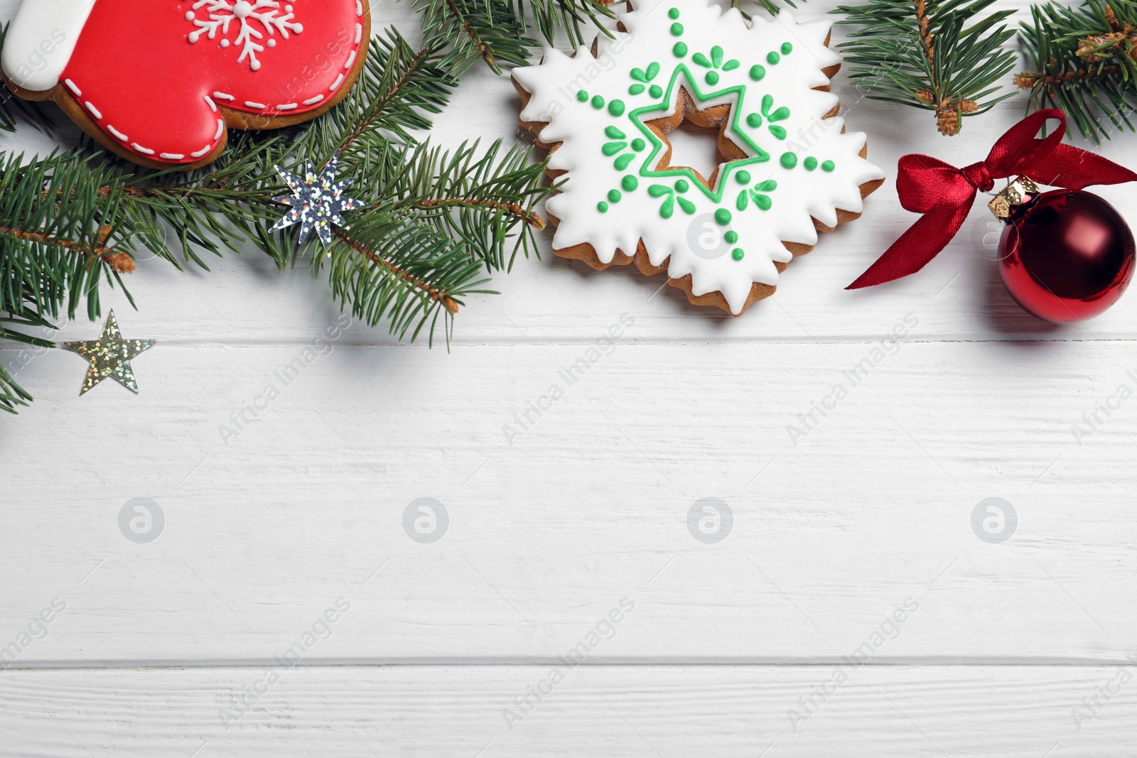 Photo of Flat lay composition with tasty homemade Christmas cookies on white wooden table, space for text