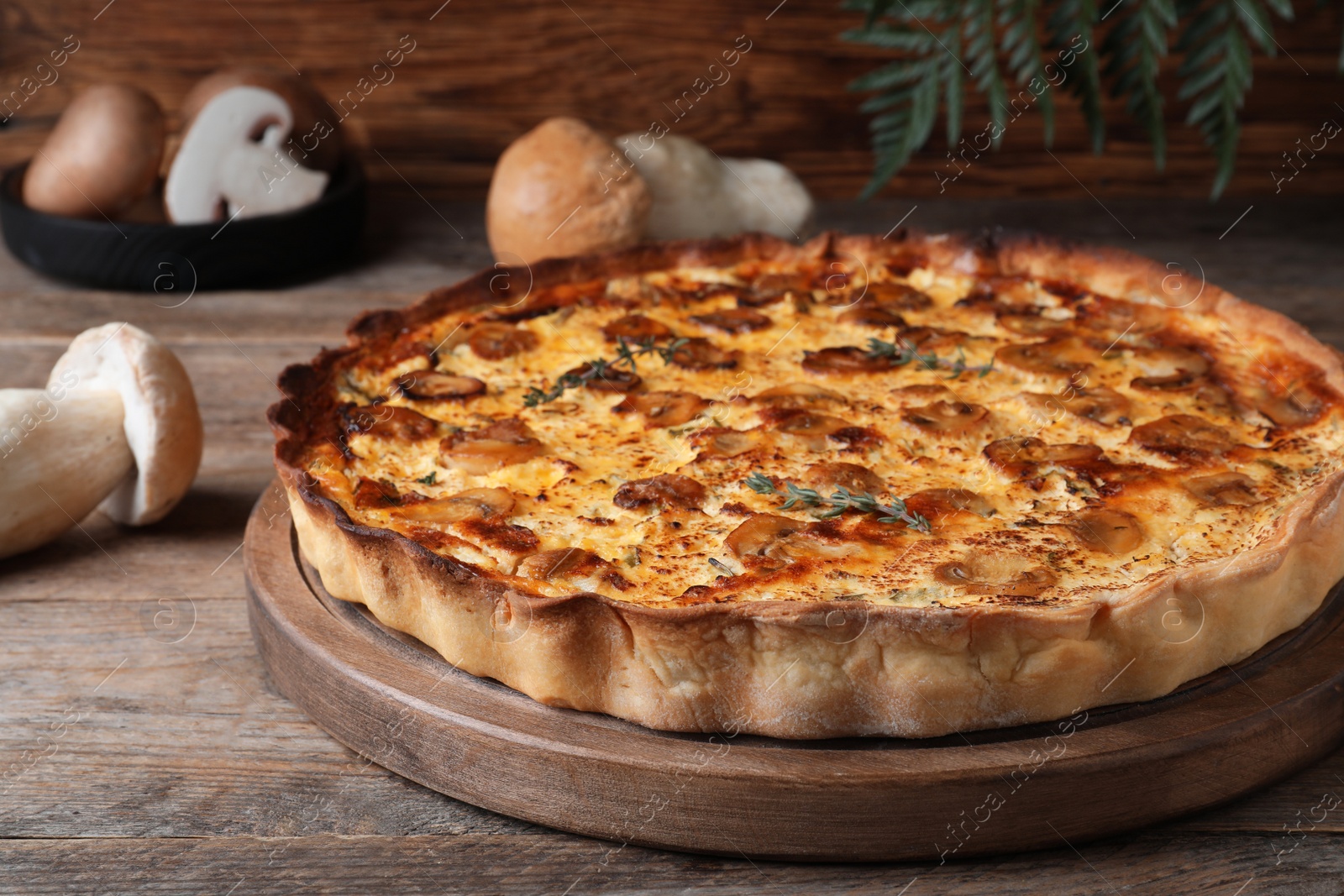 Photo of Delicious homemade mushroom pie on wooden table, closeup