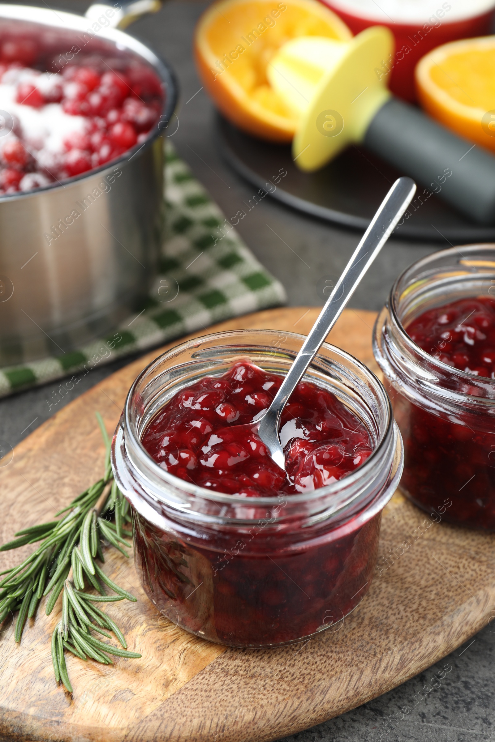 Photo of Fresh cranberry sauce in glass jars served on table
