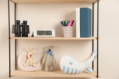 Shelves with toys and kids stuff in child room