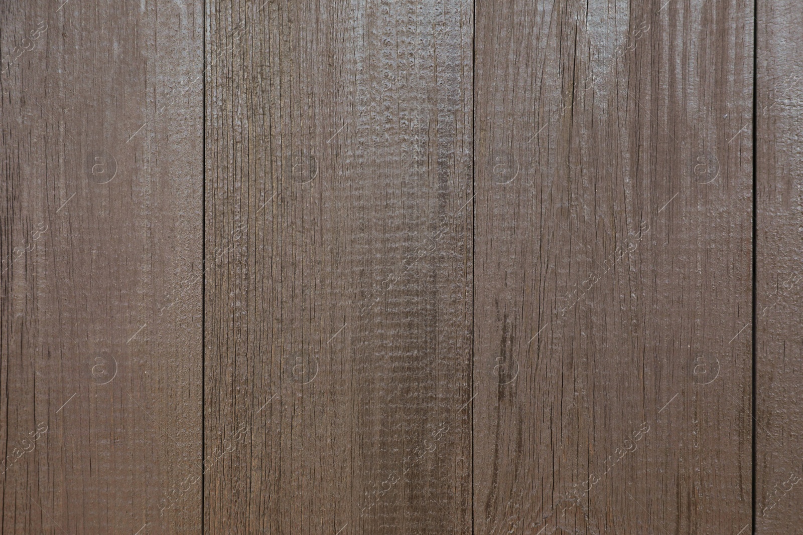 Photo of Texture of dark brown wooden surface as background, closeup