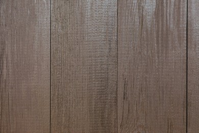 Photo of Texture of dark brown wooden surface as background, closeup